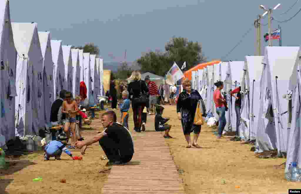 People go about their daily lives at a refugee camp set up for Ukrainians in Russia&#39;s Rostov region near the Russia-Ukraine border, Aug. 18, 2014.