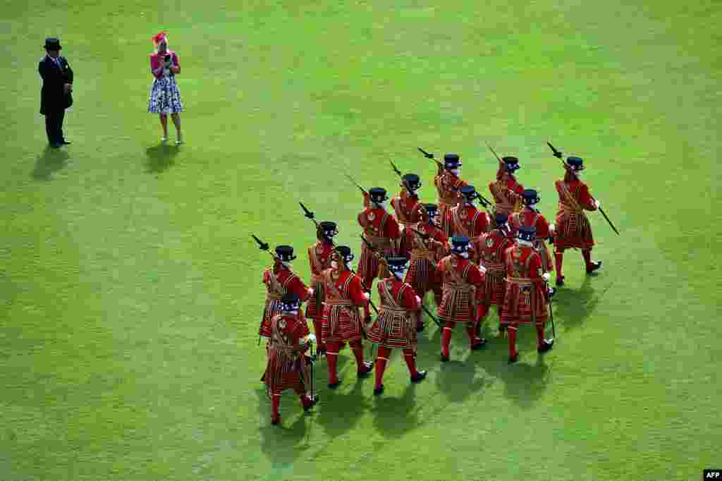 Yeomen of the Guard march during a garden party on the grounds of Buckingham Palace in central London. 
