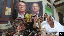 Supporters of Pakistani former Prime Minister Nawaz Sharif shout anti-government slogans outside a hospital where Sharif was admitted in Lahore, Pakistan, Oct. 24, 2019.