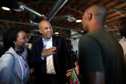 U.S. Senator and Democratic presidential candidate Cory Booker, center, talks to a supporter after speaking at a Gun Violence Prevention roundtable in Los Angeles, Aug. 22, 2019.