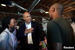 U.S. Senator and Democratic presidential candidate Cory Booker, center, talks to a supporter after speaking at a Gun Violence Prevention roundtable in Los Angeles, Aug. 22, 2019.