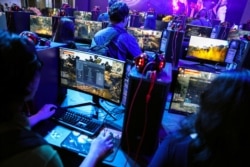 FILE - People play online games at the Thailand Game Show 2018 in Bangkok, Thailand, Oct. 26, 2018.