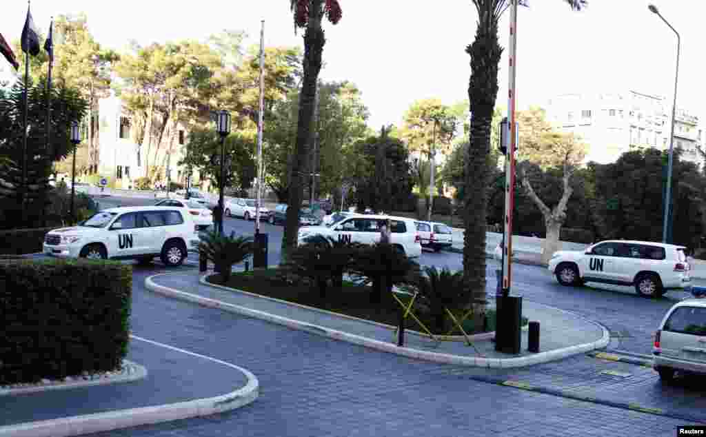 A U.N. convoy carries experts charged with starting the process of verifying and eliminating chemical weapons to a hotel in Damascus, Oct. 1, 2013.