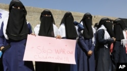Yemeni women hold a banner as they take part in a protest marking the International Women's Day in front of the U.N. building in Sanaa, Yemen, Mar. 8, 2017. Conflict and famine has led to an increase in child marriage in Yemen, according to a report by the U.N. children's agency.