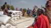 FILE - People wait to receive food at a World Vision food distribution site in Malualkuel in the Northern Bahr el Ghazal region of South Sudan, April 5, 2017. 