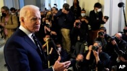 President Joe Biden speaks to the media after meeting privately with Senate Democrats, Jan. 13, 2022, on Capitol Hill in Washington. 