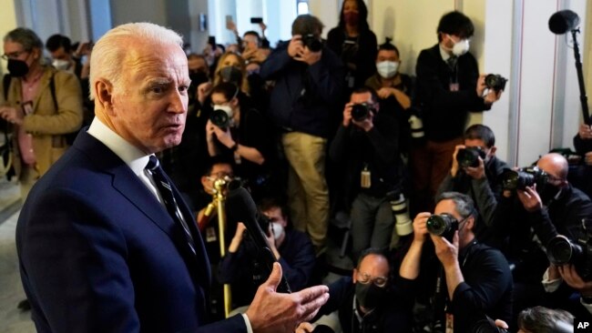 President Joe Biden speaks to the media after meeting privately with Senate Democrats, Jan. 13, 2022, on Capitol Hill in Washington.