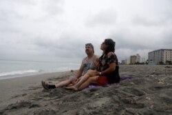 Tropical Storm Elsa churns slowly up the Gulf Coast at Venice Beach, Fla.