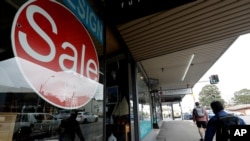 A sign advertising a 70 percent off sale is displayed in a store in Sydney, Oct. 6, 2020. 