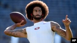 San Francisco 49ers quarterback Colin Kaepernick warms up for a preseason football game against the San Diego Chargers, in San Diego, Calif., Sept. 1, 2016. He's been criticized for refusing to stand for the national anthem. 