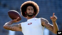 San Francisco 49ers quarterback Colin Kaepernick warms up for a preseason football game against the San Diego Chargers, in San Diego, Calif., Sept. 1, 2016. He's been criticized for refusing to stand for the national anthem. 