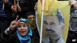 A person holds a poster of jailed Kurdish rebel leader Abdullah Ocalan as Kurdish demonstrators march in Istanbul, Turkey, April 19, 2011. 