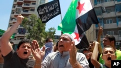 Supporters of Lebanese hard-line Sunni cleric Sheik Ahmad al-Assir hold a Syrian revolution flag and chant slogans against Hezbollah during a demonstration after the Friday prayer, in Beirut, Lebanon, July 5, 2013.