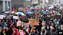 Protesters hold banners as they march during a "Rise for the Climate" demonstration in Brussels, Belgium, Jan. 27, 2019.