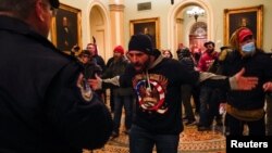 Law enforcement officers push back against supporters of U.S. President Donald Trump attempting to enter U.S. Capitol during a protest against the certification of the 2020 U.S. presidential election results by the U.S. Congress, in Washington, U.S., January 6, 2021. REUTERS/Jim 