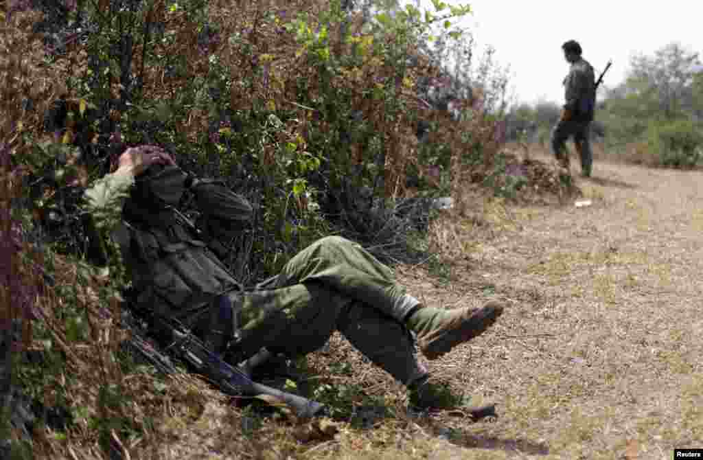 A rebel soldier of Myanmar National Democratic Alliance Army (MNDAA) rests near a military base in Kokang region, March 11, 2015. Myanmar government forces have been battling rebels on the border with China since last month and China has urged Myanmar to &quot;lower the temperature&quot;. The MNDAA was formed from remnants of the Communist Party of Burma, a powerful China-backed guerrilla force that battled the Myanmar government until it splintered in 1989. Picture taken March 11, 2015.