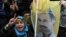 A person holds a poster of jailed Kurdish rebel leader Abdullah Ocalan as Kurdish demonstrators march in Istanbul, Turkey, April 19, 2011. 