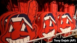 In this Jan. 29, 2018 file photo, foam images of the MLB baseball Cleveland Indians' mascot Chief Wahoo are displayed for sale at the Indians' team shop in Cleveland. 