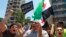 Supporters of Lebanese hard-line Sunni cleric Sheik Ahmad al-Assir hold a Syrian revolution flag and chant slogans against Hezbollah during a demonstration after the Friday prayer, in Beirut, Lebanon, July 5, 2013.