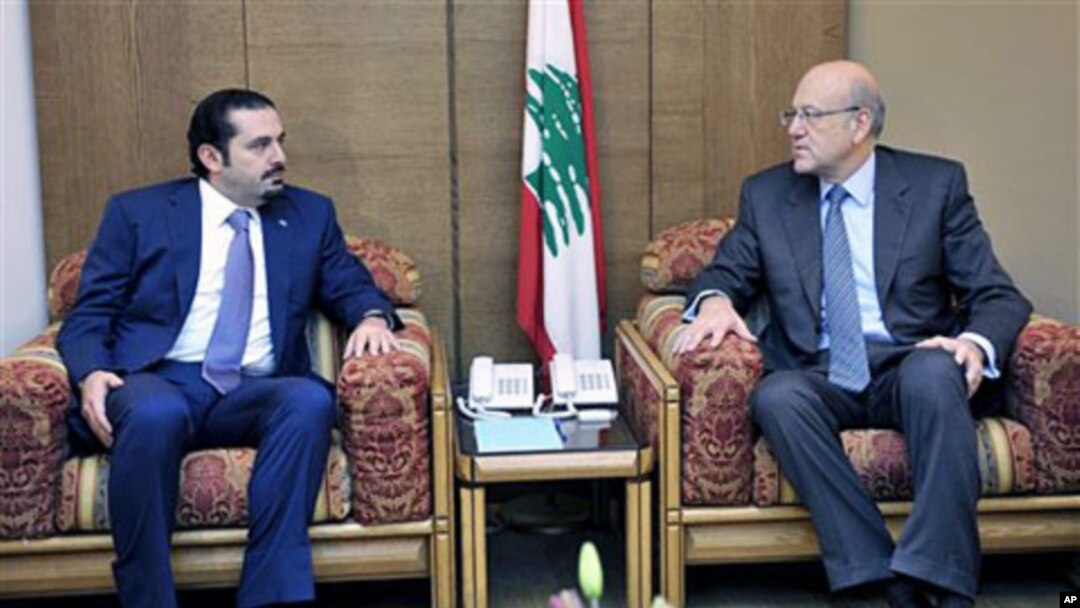Lebanon's PM-designate Najib Mikati (R) meets with caretaker PM Saad Hariri (L) at the Parliament during consultations to form a new cabinet, Beirut, Jan 27 2011