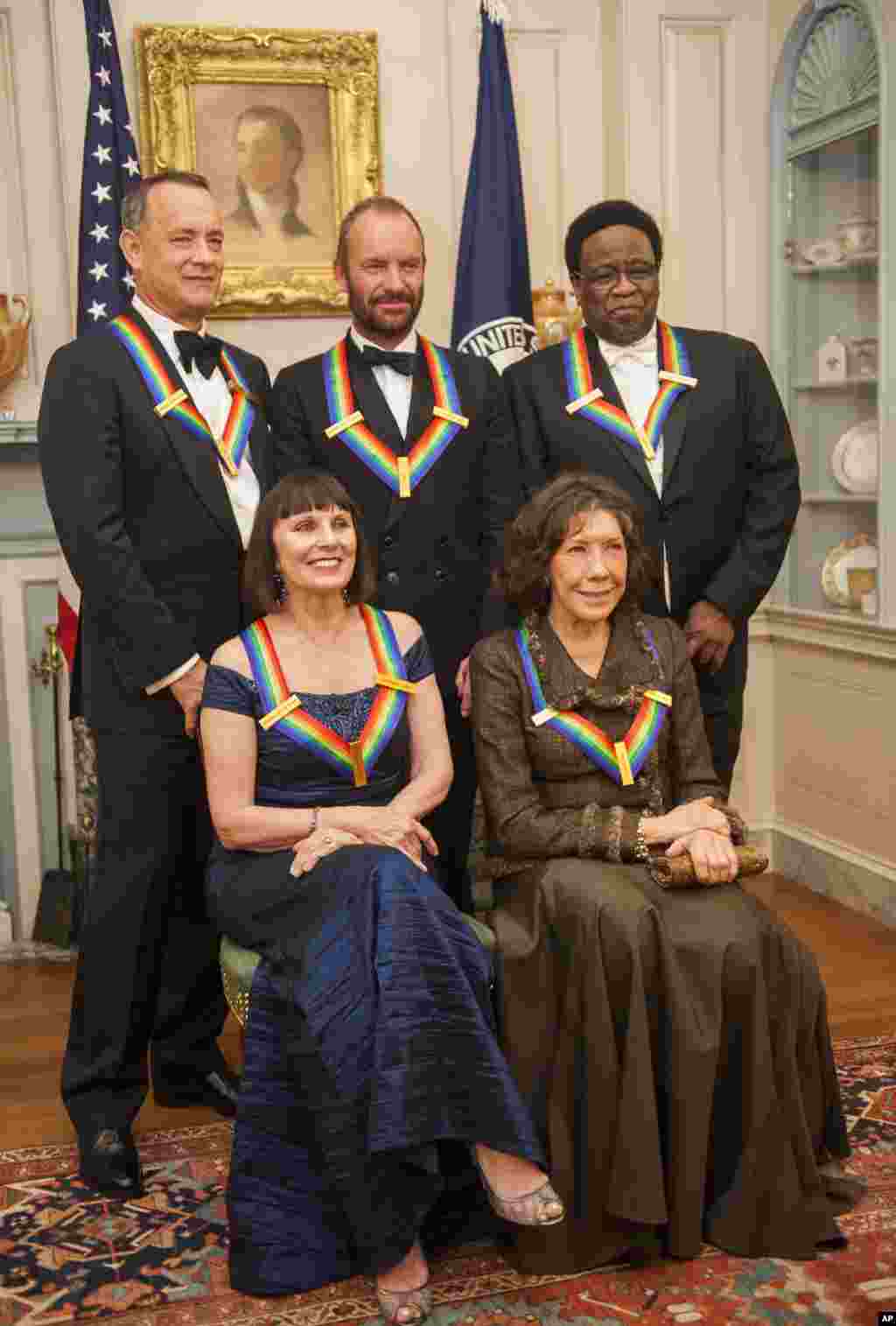 From left, 2014 Kennedy Center Honorees Tom Hanks, Patricia McBride, Sting, Lily Tomlin and Al Green pose for a photo following the State Department Dinner for the Kennedy Center Honors at the State Department, Dec. 6, 2014.