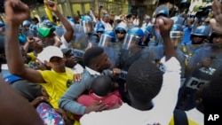 Protesters clash with police near parliament in Cape Town, South Africa, Feb. 9, 2017 prior to it's opening and a national address by President Jacob Zuma. Hundreds of armed forces have been deployed to increase security as opposition groups denounce Zuma, saying he should resign.