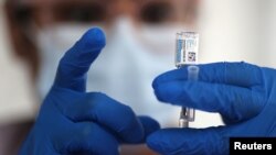 FILE - A nurse draws from a vial of Johnson & Johnson coronavirus vaccine, in Los Angeles, California, March 25, 2021. 