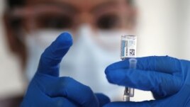 FILE - A nurse draws from a vial of Johnson & Johnson coronavirus vaccine, in Los Angeles, California, March 25, 2021.