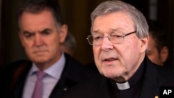 Australian cardinal George Pell reads a statement to reporters as he leaves the Quirinale hotel after meeting members of the Australian group of relatives and victims of priestly sex abuses, in Rome, March 3, 2016. 