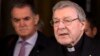 Australian cardinal George Pell reads a statement to reporters as he leaves the Quirinale hotel after meeting members of the Australian group of relatives and victims of priestly sex abuses, in Rome, March 3, 2016. 