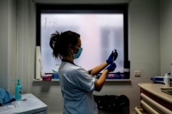 FILE - A nurse prepares a dose of the AstraZeneca COVID-19 vaccine at the Edouard Herriot hospital, Feb. 6, 2021, in Lyon, France.