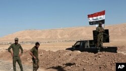 Shiite Popular Mobilization Forces take control of a former Kurdish security forces checkpoint outside Bashiqa, Iraq, Oct. 18, 2017. 