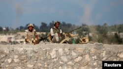 Egyptian soldiers keep guard on the border between Egypt and southern Gaza Strip, July 8, 2013, after armed men launched a series of attacks on security checkpoints in the North Sinai towns of Sheikh Zuweid and El Arish.