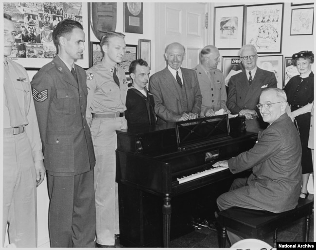 President Truman playing the piano in the White House