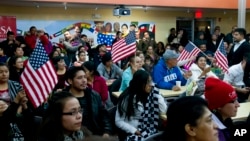 Người gốc châu Mỹ Latinh theo dõi bài diễn văn của Tổng thống Obama về cải cách di trú tại Casa de Maryland ở Hyattsville, bang Maryland, ngày 20/11/2014.