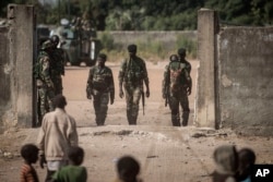 Local children, foreground, look toward Senegal soldiers at the Gambia border with Senegal at the town of Karang, Senegal, Jan. 20, 2017.