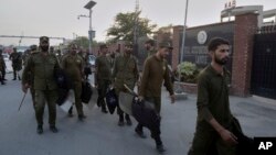 Pakistani police officers arrive to take positions for security at the office of National Accountability Bureau following the opposition leader arrest, in Lahore, Pakistan, Oct. 5, 2018. 