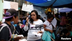 Psychologist Mayra Campos talks to a couple in a provisional camp after an earthquake in Xochimilco on the outskirts of Mexico City, Mexico, Sept. 25, 2017.