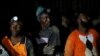 File- Miners look on after they retrieved the bodies of two other miners from Johannesburg's oldest gold mine in Langlaagte, South Africa, September 13, 2016.