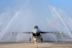 FILE - A U.S.-made F-16V fighter jet is cleaned by an auto washing machine during a military exercise in Chiayi County, southern Taiwan, Jan. 15, 2020.