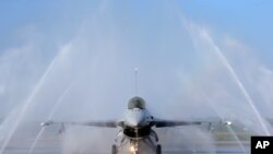 FILE - A U.S.-made F-16V fighter jet is cleaned by an auto washing machine during a military exercise in Chiayi County, southern Taiwan, Jan. 15, 2020. 