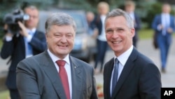 Ukrainian President Petro Poroshenko, left, and NATO Secretary General Jens Stoltenberg, shakes hands during a meeting in Kiev, Ukraine, Monday, July. 10, 2017. 