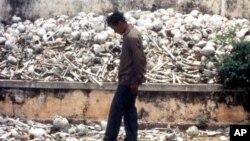 FILE - A Cambodian man is seen at one of the Killing Fields where vast numbers of people were killed by the Khmer Rouge regime.