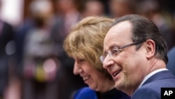 French President Francois Hollande, right, talks next to EU foreign policy chief Catherine Ashton, during an EU summit at the European Council building in Brussels, Friday, Dec. 20 2013.