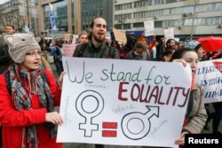 Demonstrators hold a placard during a rally for gender equality and against violence towards women on International Women's Day in Kyiv, Ukraine, March 8, 2017.