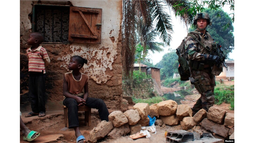 A French soldier patrols in a neighbourhood during a daytime patrol as shooting continued overnight the capital Bangui, Central African Republic, Dec. 26, 2013.