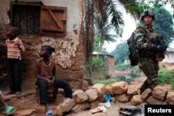 A French soldier patrols in a neighbourhood during a daytime patrol as shooting continued overnight the capital Bangui, Central African Republic, Dec. 26, 2013.