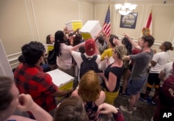 University students pass around boxes of petitions for Florida Governor Rick Scott in the governor's office inside the Florida Capitol in Tallahassee, Feb 21, 2018. A week after a shooter killed more than a dozen people in a Florida high school, thousands of protesters, including many angry teenagers, swarmed into the state Capitol on Wednesday, calling for changes to gun laws.