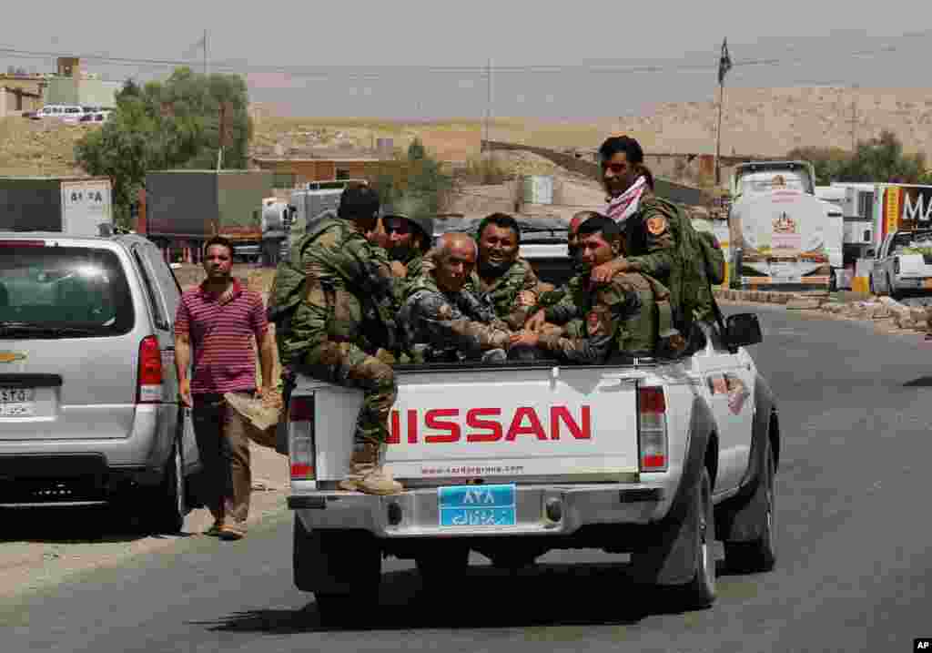 Kurdish forces, known as the Peshmerga, on their way to the front line to fight Islamic State extremists, Mosul Dam, outside Mosul, Iraq, Aug. 18, 2014.