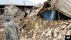 People walk around a destroyed house in Karakocan province of southeastern city Elazig, 08 Mar 2010